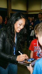 Kelsey Plum signing autographs for young fans at a community event. — Kelsey Plum Wallpaper