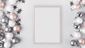 Blank picture frame surrounded by holiday ornaments and stars on a gray background. — Gold Balloons PNG