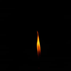 A single flame burning in darkness — Flame Wallpaper