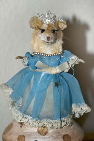 A small mouse figurine wearing a blue princess dress and crown. — Funny Cute Animals Picture