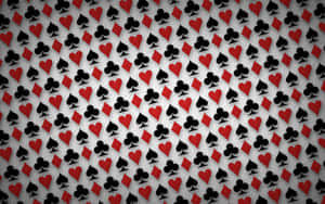 Fondo de pantalla con palos de naipes rojos y negros repetidos sobre gris. — Fondods de juegos Fondos