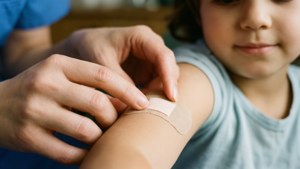 Lähikuva sairaanhoitajan käsistä sitomassa lasta Nurse Day -taustakuvaa varten
