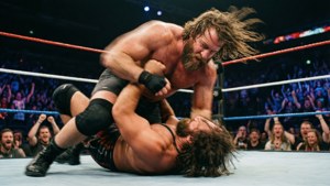 Action shot of Jonathan Gresham performing a technical wrestling move during a match.