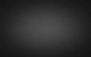 Fondo minimalista de degradado gris oscuro con desvanecimiento suave a negro en los bordes.