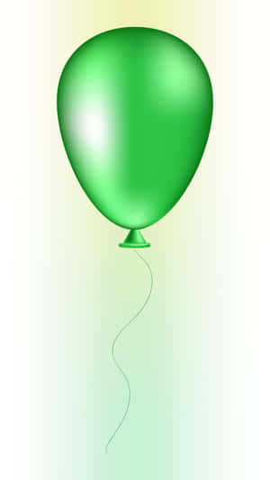 Un ballon vert flottant avec une ficelle sur un fond dégradé doux.