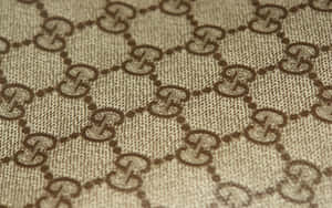 Beige fabric with brown interlocking G logo pattern. — Gucci Wallpaper