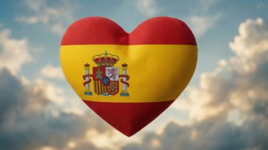 A romantic wallpaper of the Spain flag shaped as a heart floating in a cloudy sky.