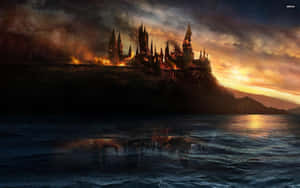 A burning castle on a cliff reflected in dark water at sunset.