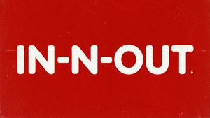 Minimalistisk typografi-bakgrunnsbilde med fet hvit 'IN-N-OUT'-tekst på rød bakgrunn