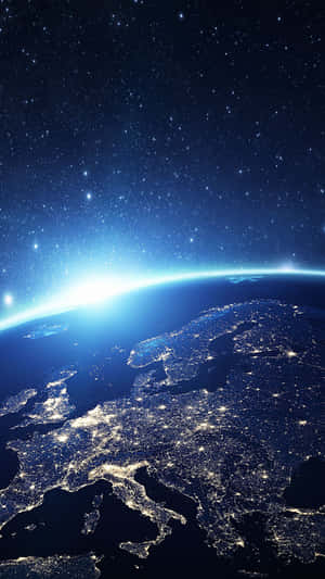 Night view of Earth from space showing Europe's city lights and starry sky. — iPhone Earth Picture