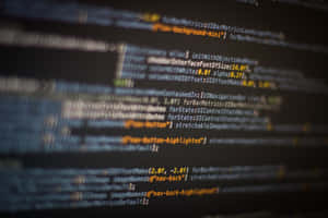 Glowing lines of code on a dark screen with shallow depth of field. — Computer Science Picture