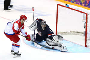 Hockey player skating toward goalie during intense game play.