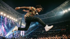 Quavo jumping energetically on stage with confetti. — Quavo Picture