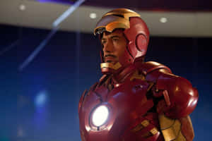Tony Stark in Iron Man suit with glowing chest reactor in futuristic setting. — Iron Man Picture