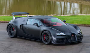 Bugatti Veyron Super Sport preto fosco estacionado perto de lago com grama verde e borda de pedra. — Preto fosco Papéis de Parede