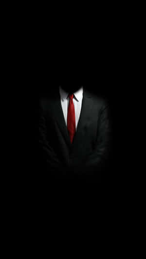 A person in a suit and red tie with no face visible against a black background. — Men Background