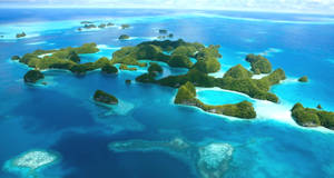 Aerial view of tropical islands with turquoise waters and white sandy beaches.
