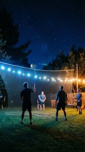 Spikeball under string lights at night