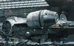Millennium Falcon spaceship in a hangar with exposed wiring and industrial lighting. — Millenium Falcon Picture