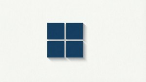 Four blue squares forming a window logo on a white textured wall. — Microsoft Wallpaper