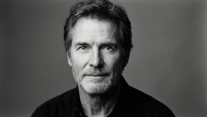 A clean studio portrait of Kevin Kline with a minimalist backdrop.