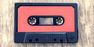 Red and black cassette tape on wooden background — Psychedelic Colors Background