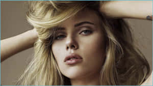Blonde woman with hands in her hair looking directly at camera. — Model Picture