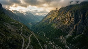 A dramatic mountain road with twists and cinematic lighting.