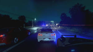 Nighttime highway racing scene with glowing car taillights and streetlights. — Need For Speed Desktop Picture