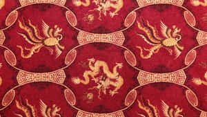 Red fabric with golden dragons and phoenixes in traditional Chinese design.
