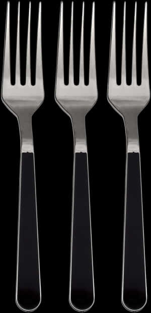 Three identical forks with black handles against a black background. — Fork SVG