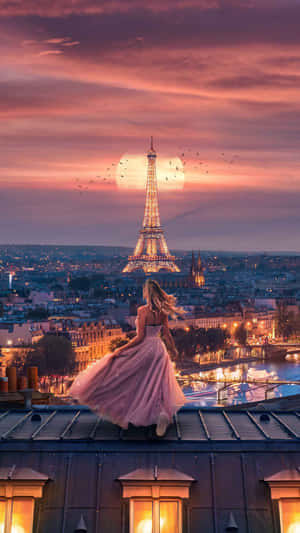 Woman in pink dress on Paris rooftop watching Eiffel Tower at sunset. — Paris Wallpaper