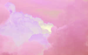 Pastel pink and lavender clouds with a soft yellow glow in a dreamy sky. — Pink And Blue Clouds Picture