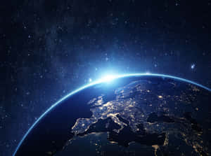 Earth viewed from space with city lights and sunrise over Europe