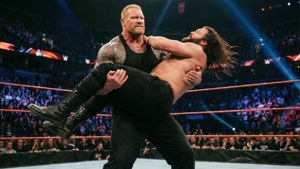 Two wrestlers locked in combat inside a wrestling ring with cheering fans. — Braun Strowman Wallpaper