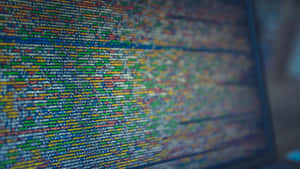 Vibrant lines of computer code flowing across a glowing digital screen. — Programming Picture
