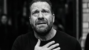 Emotional Paul Heyman in black and white.