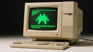 A vintage computer with CRT monitor, beige case, and green glowing pixel art screen.