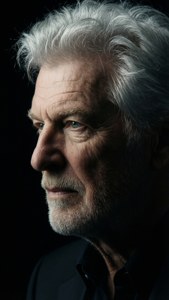 Side profile of Donald Sutherland with dramatic shadowing.