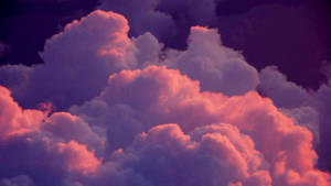 Dramatic clouds illuminated in pink and purple at dusk. — Clouds Background