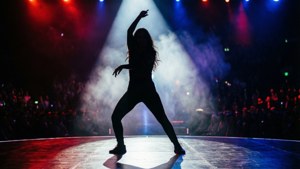 Artistic silhouette of a dancer on the AGT stage under dramatic lights — America's Got Talent Wallpaper