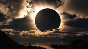 Silhouette of a person watching a planet eclipse the sun over water at sunset. — HD Computer Picture