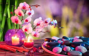 Pink orchids candles and stones arranged on a bamboo mat for relaxation. — Calming Wallpaper