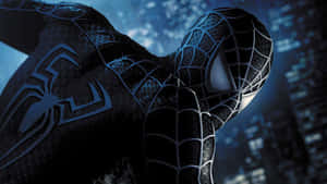 Spider-Man in black suit with glowing blue webbing against a nighttime city backdrop.