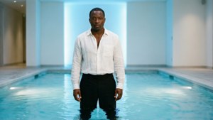 Jerry Lorenzo dans une piscine intérieure calme, avec des reflets d'eau et une ambiance minimaliste sereine