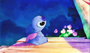 A blue alien with big eyes sits on a wooden platform at night near glowing pink flowers. — Lilo Stitch Picture