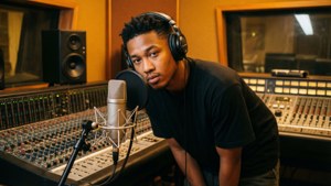 JayDaYoungan in the recording studio, focused on music creation.