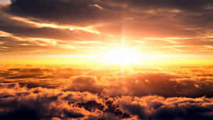 Sunset over clouds with golden light and orange hues. — Here Comes The Sun Picture