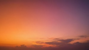 A warm sunset gradient background with soft cloud transitions, calming and beautiful.