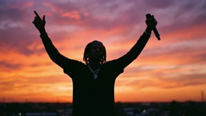 Silhouet van Lil Wayne bij zonsondergang met microfoon